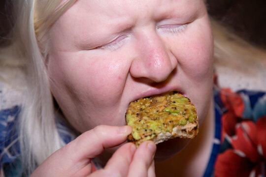 Woman Eating Avocado Toast