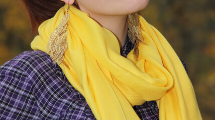 yellow handkerchief around the neck of a girl in a checkered purple shirt