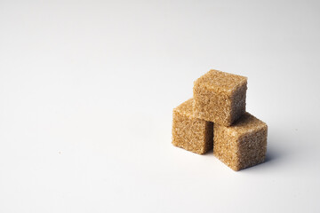 pieces of cane brown sugar on white background