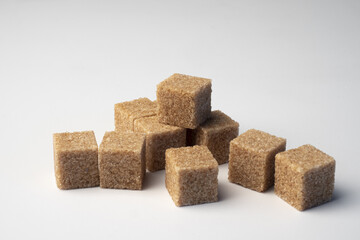 pieces of cane brown sugar on white background