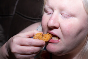 Woman Eating Chicken Tender