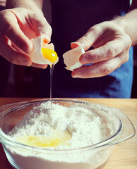 Making the dough adding eggs to the flour.Cooking process