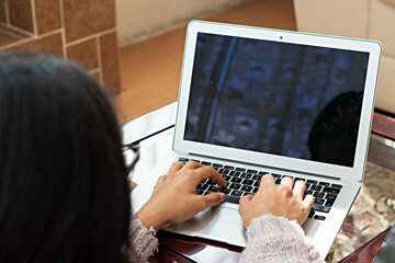 young man doing home office, typing on laptop
