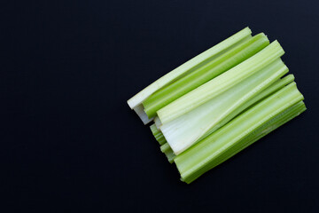 Fresh celery on dark background.