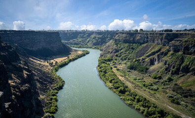 Winding Snake River flowing thru the pacific northwest in the summertime on a partly cloudy day