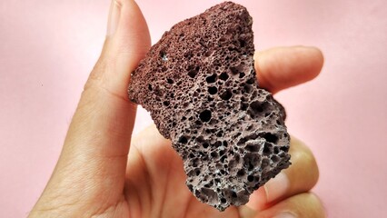 specimen Scoria igneous rock, black and brownish red color from the central java volcano, Indonesia. Basaltic lava, oxidation of iron during eruptions. Rocks and minerals identification 