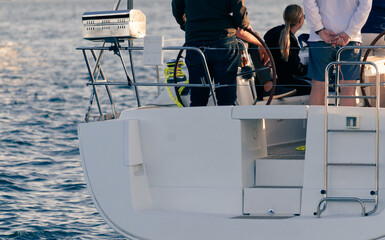 A young crew enjoys a leisurely sail on a 43-foot sailboat in Sydney harbor. Detail of the stern....