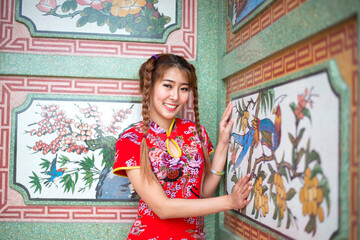 Chinese woman red dress traditional cheongsam ,close up portrait in chinese temple.