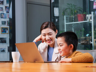 Mom and kids watch laptops