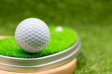 Golf ball is on green grass