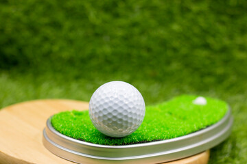Golf ball is on green grass background