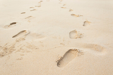 Footprints of shoes on the beach