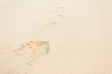 Footprints of shoes on the beach