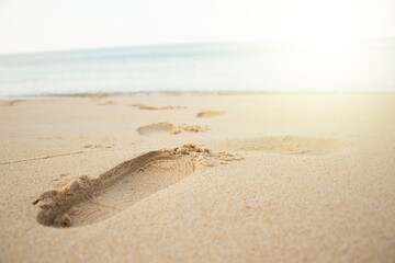 Footprints of shoes on the beach