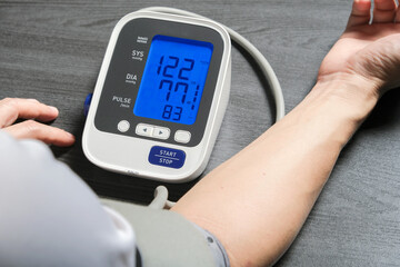 Man check blood pressure monitor and heart rate monitor with digital pressure gauge. Health care and Medical concept