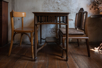 Antique set of old table and chair interior with vintage grunge white wall texture decoration with blank space for text