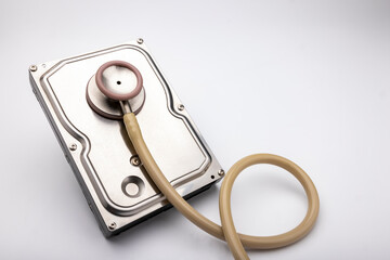 Computer hard disk and stethoscope on white background , Checking Security concept