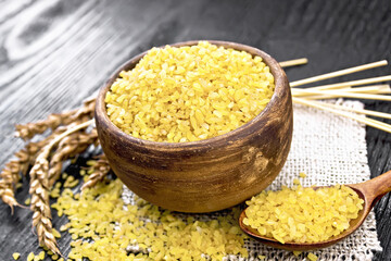 Bulgur in bowl on black board