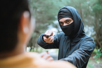 Criminal bandit force knife to rob victim on the street