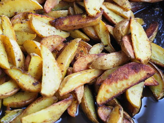 potato slices baked in butter with oregano turmeric and curry