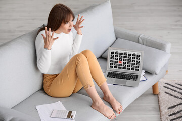 Stressed young woman trying to meet deadline at home
