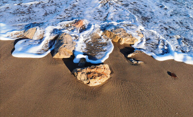 Closeup of the seafoam on the seashore