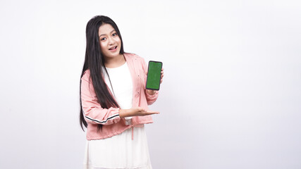 Fototapeta premium beautiful asian woman pointing green screen in handphone isolated white background