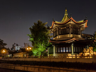 Illuminated pagoda in an Asian historical ancient style park, night shot 
