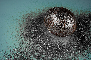 Trendy easter background with shiny gray colored egg and with glitters around. Creative spring holiday image with painted chicken egg. Top view flat lay still life. Easter concept.