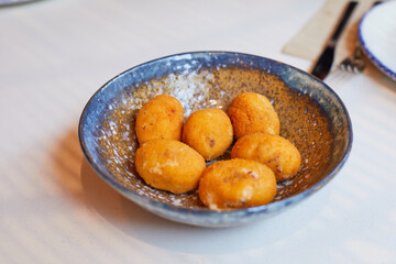 six croquettes in a bowl in table of restaurant