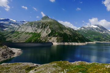 Fototapeta na wymiar hydroelectric power plant with a huge dam in a beautiful mountain landscape