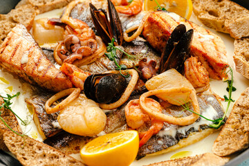 Closeup on seafood saute mix with cream sauce and herbs