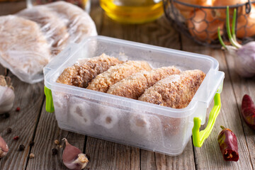 Frozen cutlets in a container. Ready frozen food. Fast cooking concept.