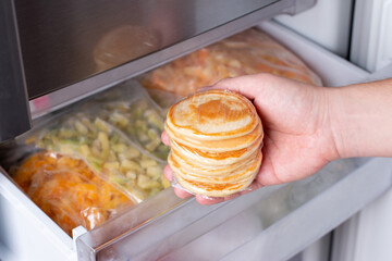 Frozen pancakes in the freezer. Ready frozen food