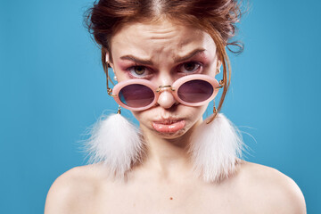 emotional woman wearing dark round glasses naked shoulders decoration closeup isolated background