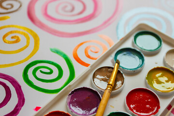 Pattern of colored painted spirals from watercolor paints and gouache