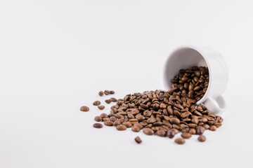 white cup of coffee with sprinkled coffee beans