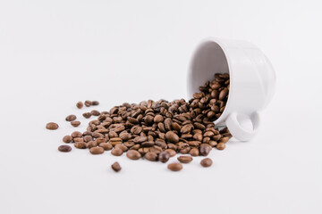 white cup of coffee with sprinkled coffee beans