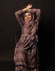 Fashion portrait of young beautiful asian muslim woman with wearing hijab on black background