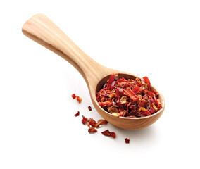 Chopped dried chili, paprika seasoning in a wooden spoon isolated on white background