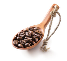 Obraz premium Coffee beans in a wooden spoon isolated on white background