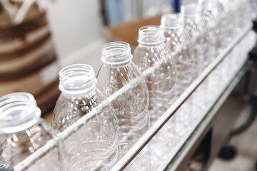 PET plastic bottles on a food automated line, milk and yoghurt bottling industry in dairy factory