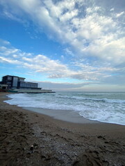 A unique palette of colors and shades of blue barely cloudy sky over the calm azure surf of the Black Sea coast.