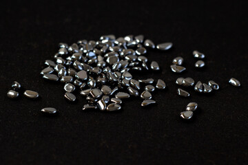 Hematite mineral texture as nice natural texture background on black cloth close up