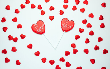 Two heart shaped lollipops with Love inscription. Valentine's Day composition.