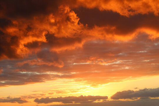 Colorful sunset sky background with orange clouds in twilight time