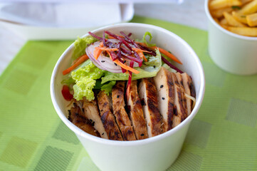 Grilled chicken with vegetables noodle meal in a box