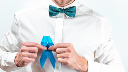 Blue ribbon. Awareness prostate cancer of men health in November. Hipster men in bright shirt, cyan...