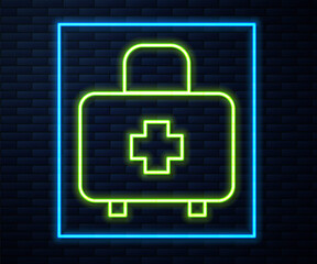 Glowing neon line First aid kit icon isolated on brick wall background. Medical box with cross. Medical equipment for emergency. Healthcare concept. Vector.