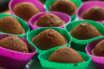 Chocolate cupcakes with a delicious crust in baskets with selective focus